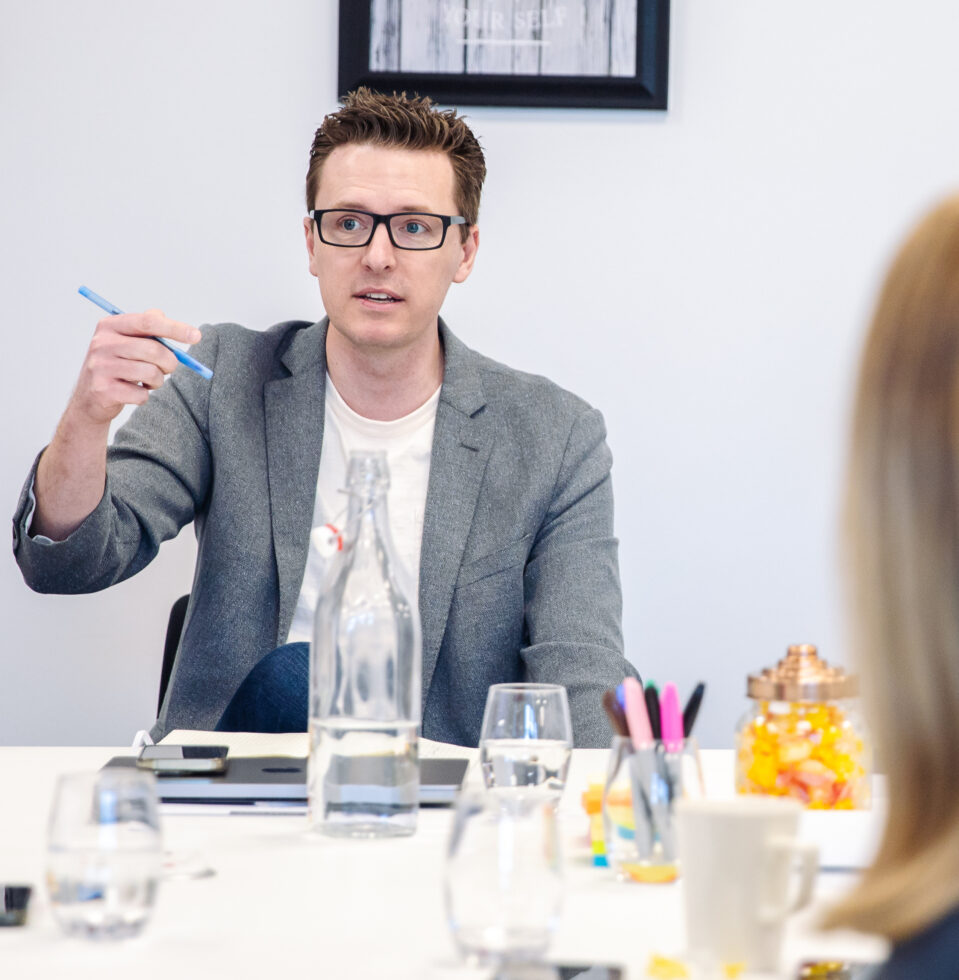 Image depicting Cody Rowland, the President of Cegos US and Author of this article, explaining the benefits of Manager Integration programmes in a workshop.